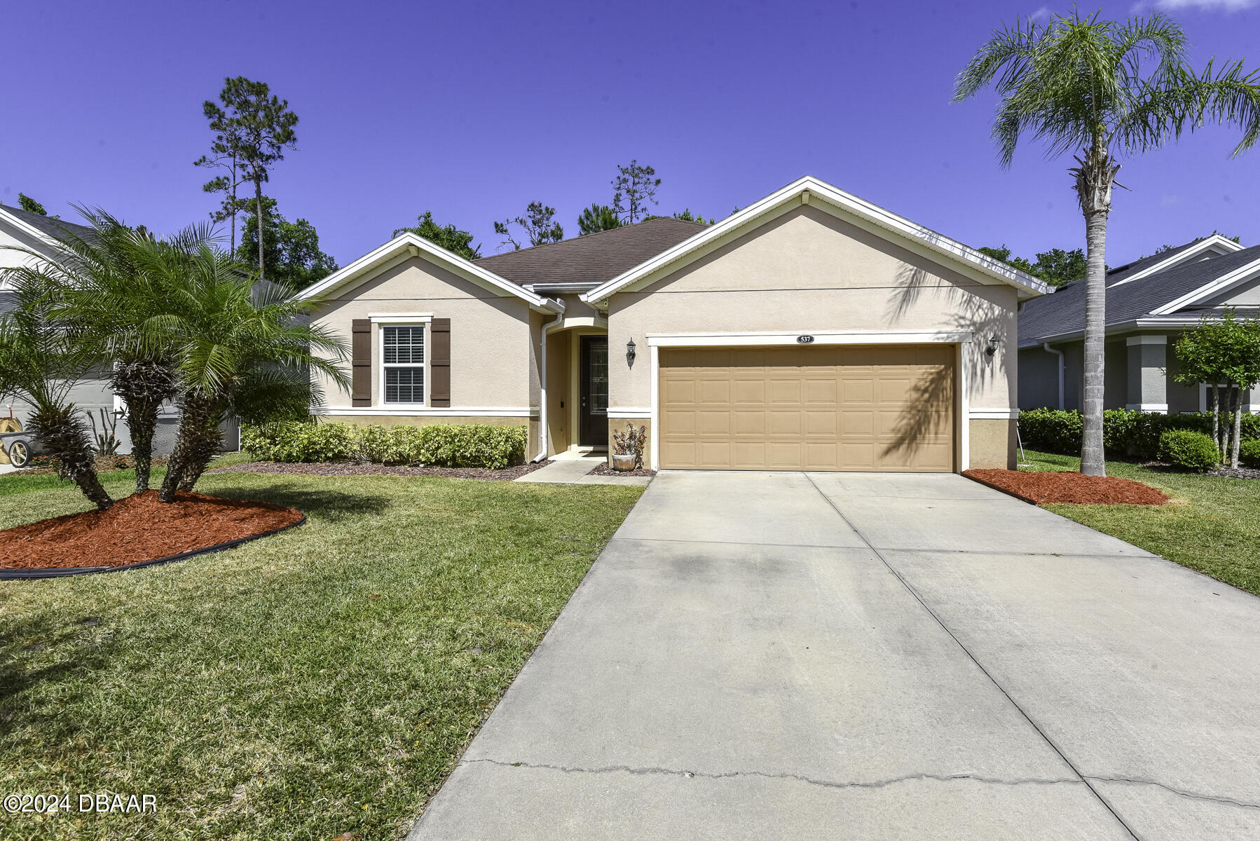 a front view of a house with yard