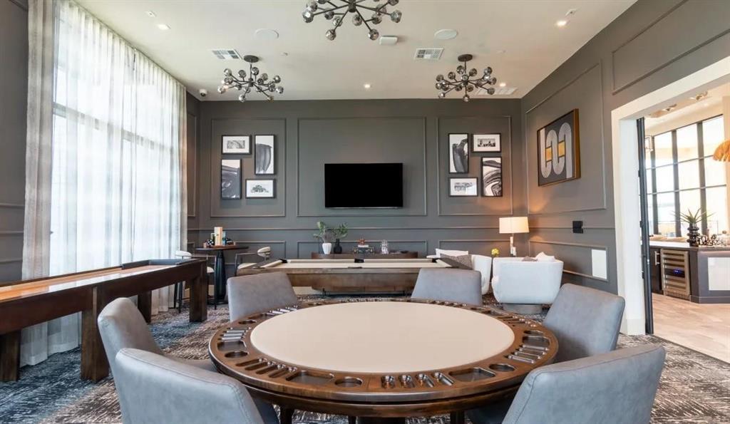 a living room with furniture a chandelier and a flat screen tv