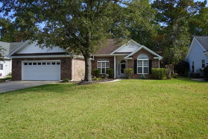 Single story home with a front lawn and a garage