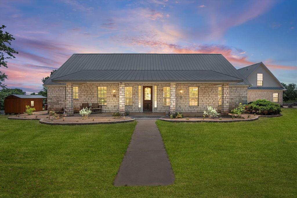 a view of a house with backyard patio and swimming pool