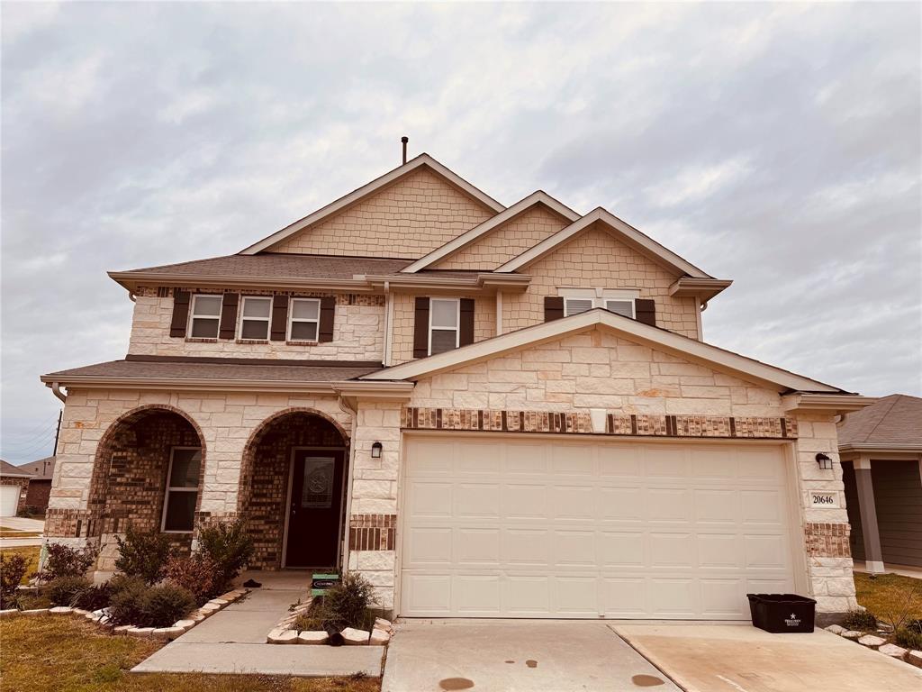 a front view of a house with garage