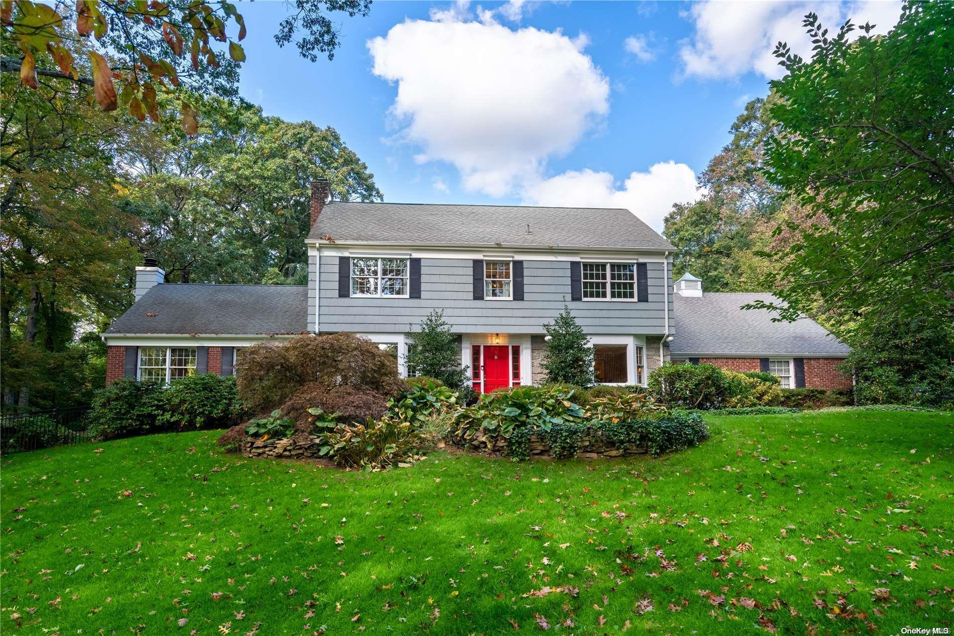 a front view of house with yard and green space