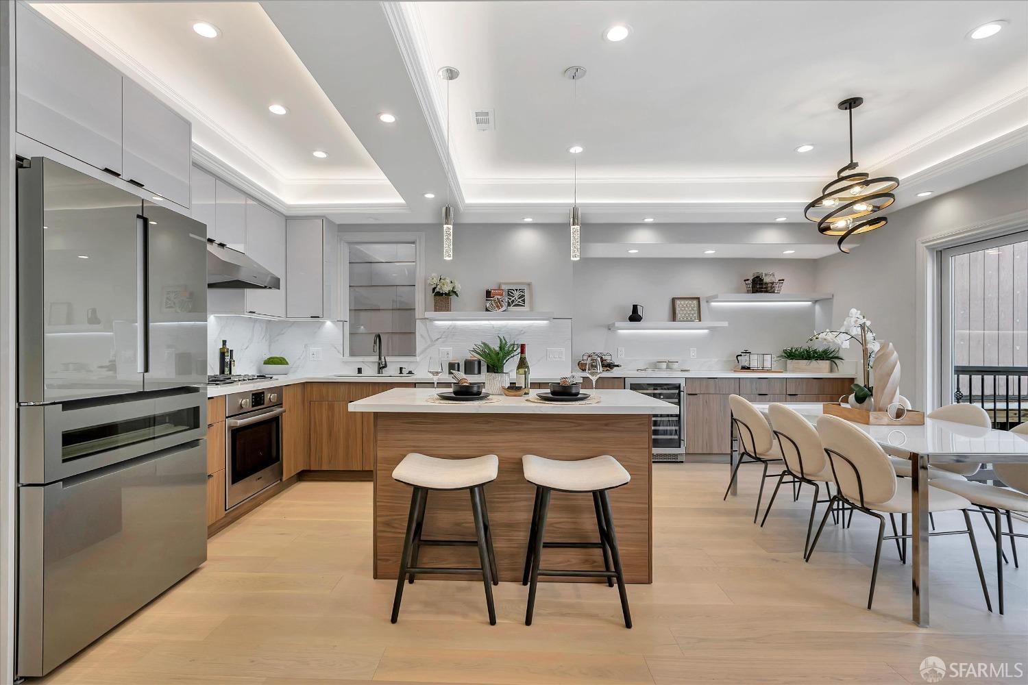 a kitchen with stainless steel appliances kitchen island granite countertop a table chairs sink and cabinets