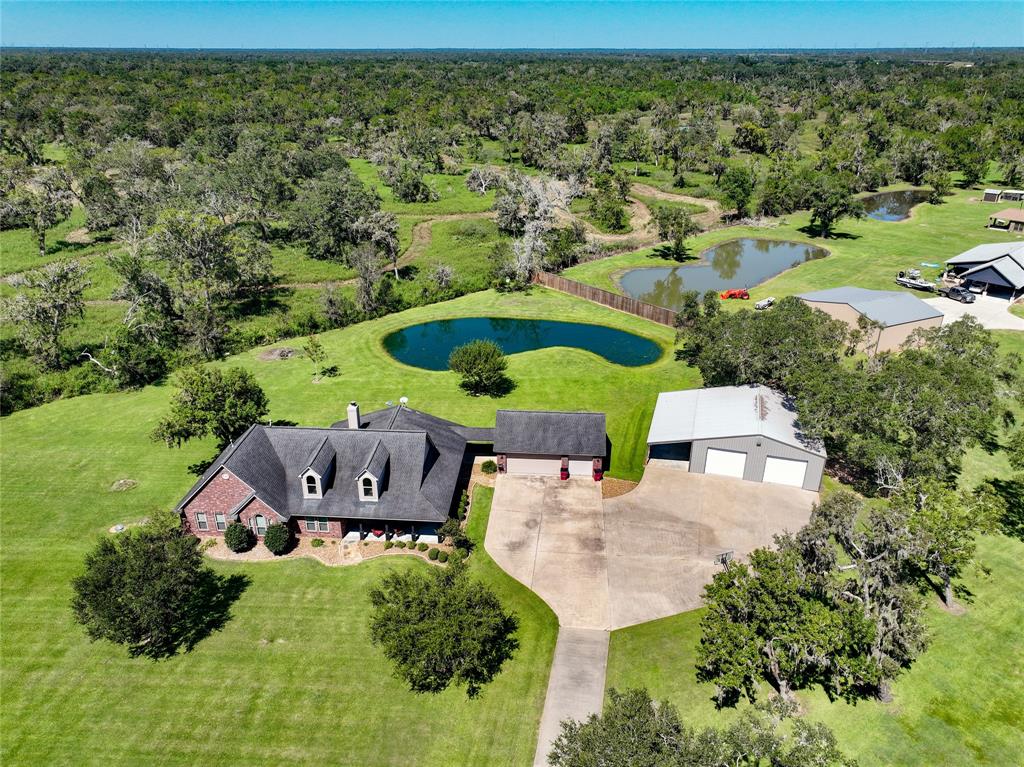 an aerial view of a house with garden space and outdoor seating