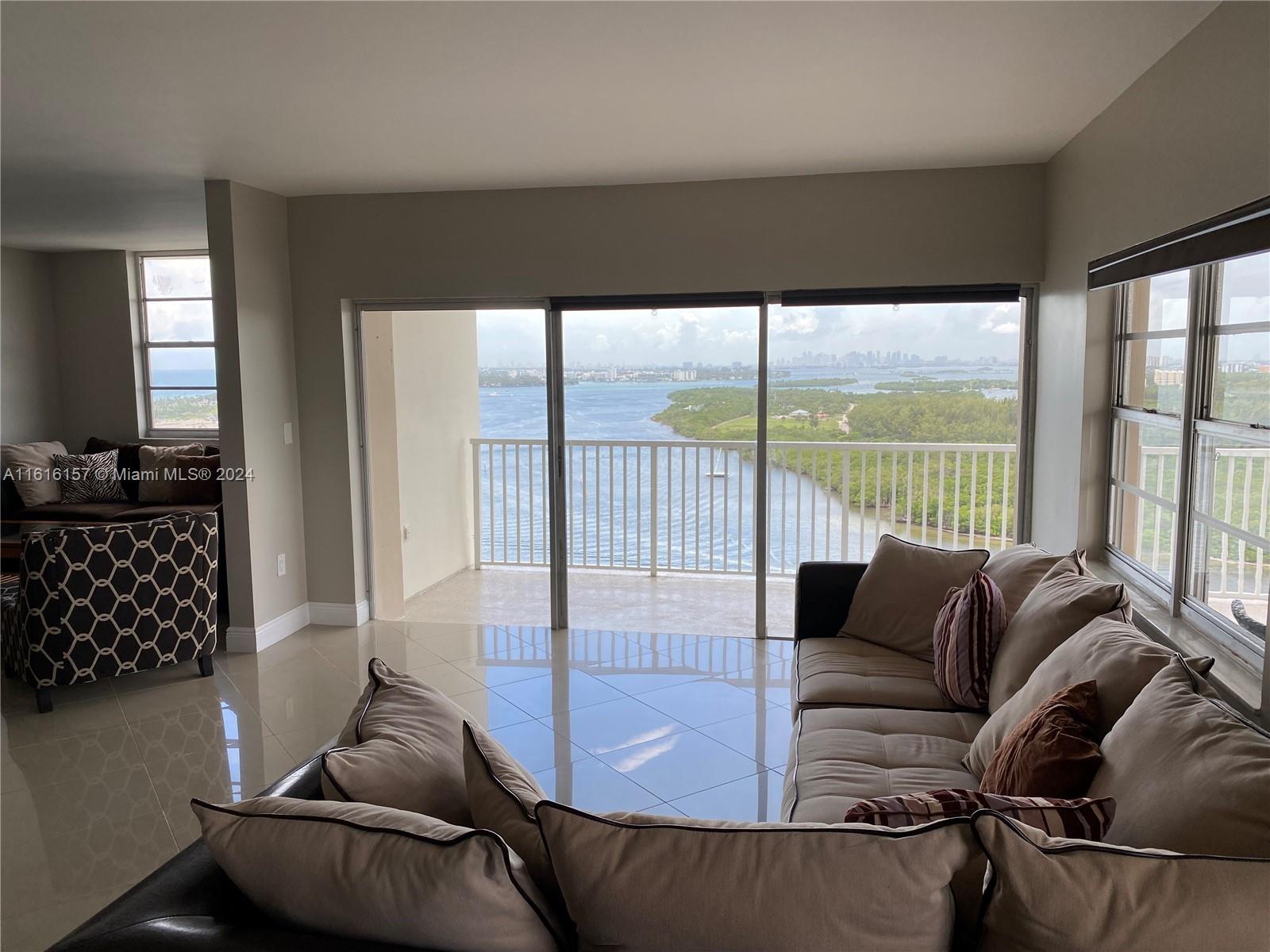 a living room with furniture and a floor to ceiling window