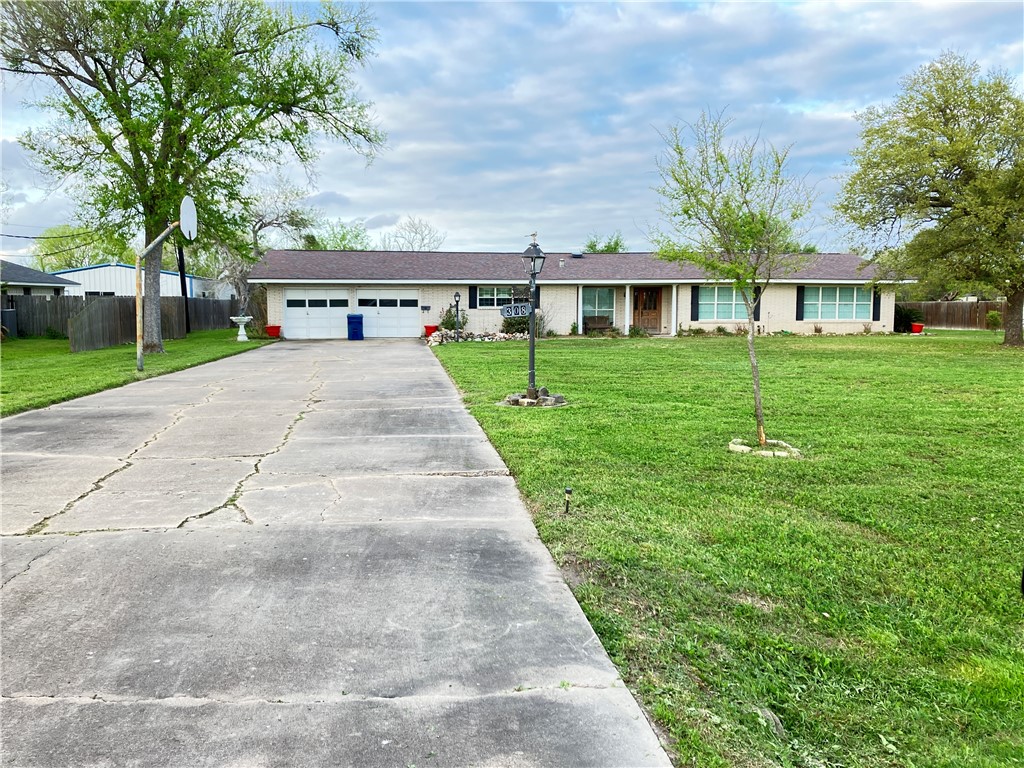 a view of house with a yard