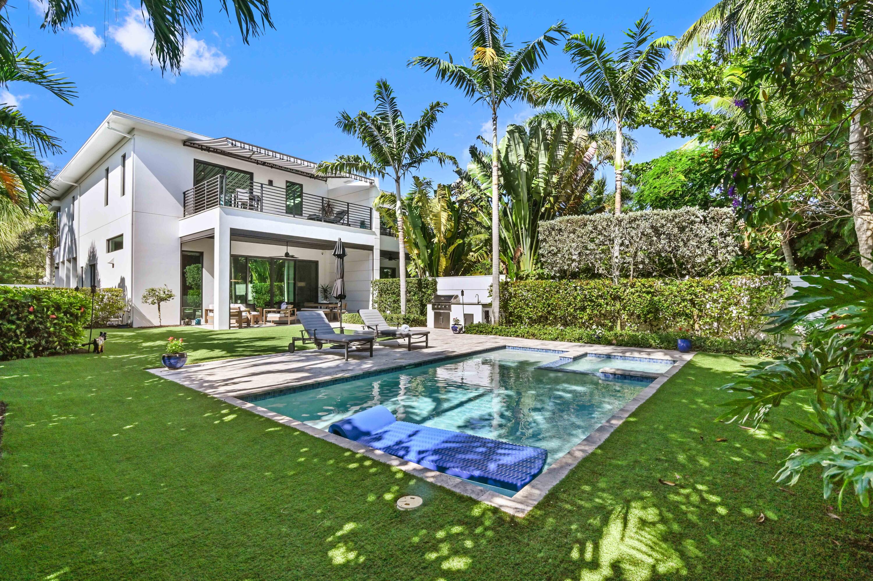 a view of a house with swimming pool and sitting area