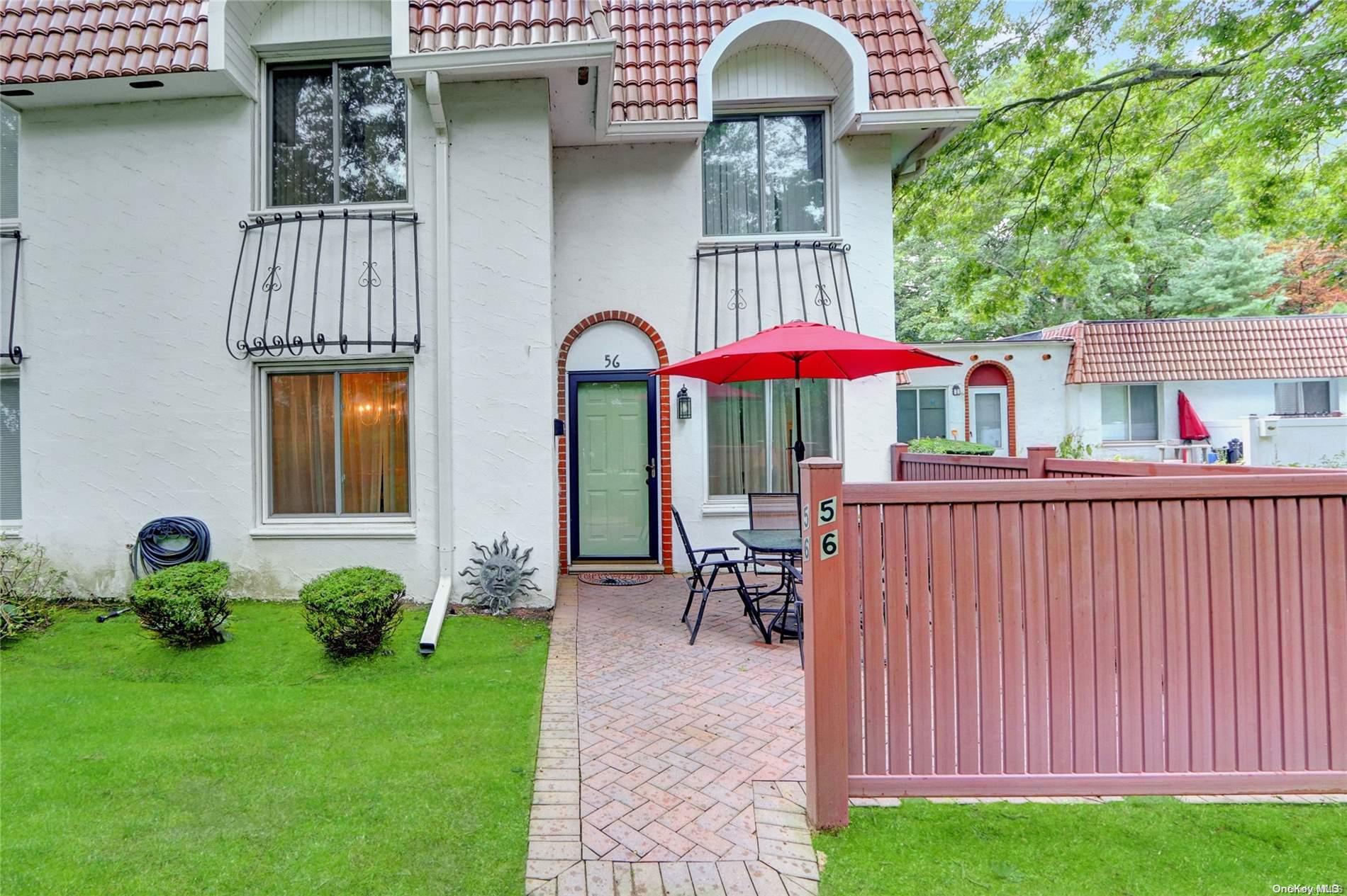 a view of a house with backyard and porch