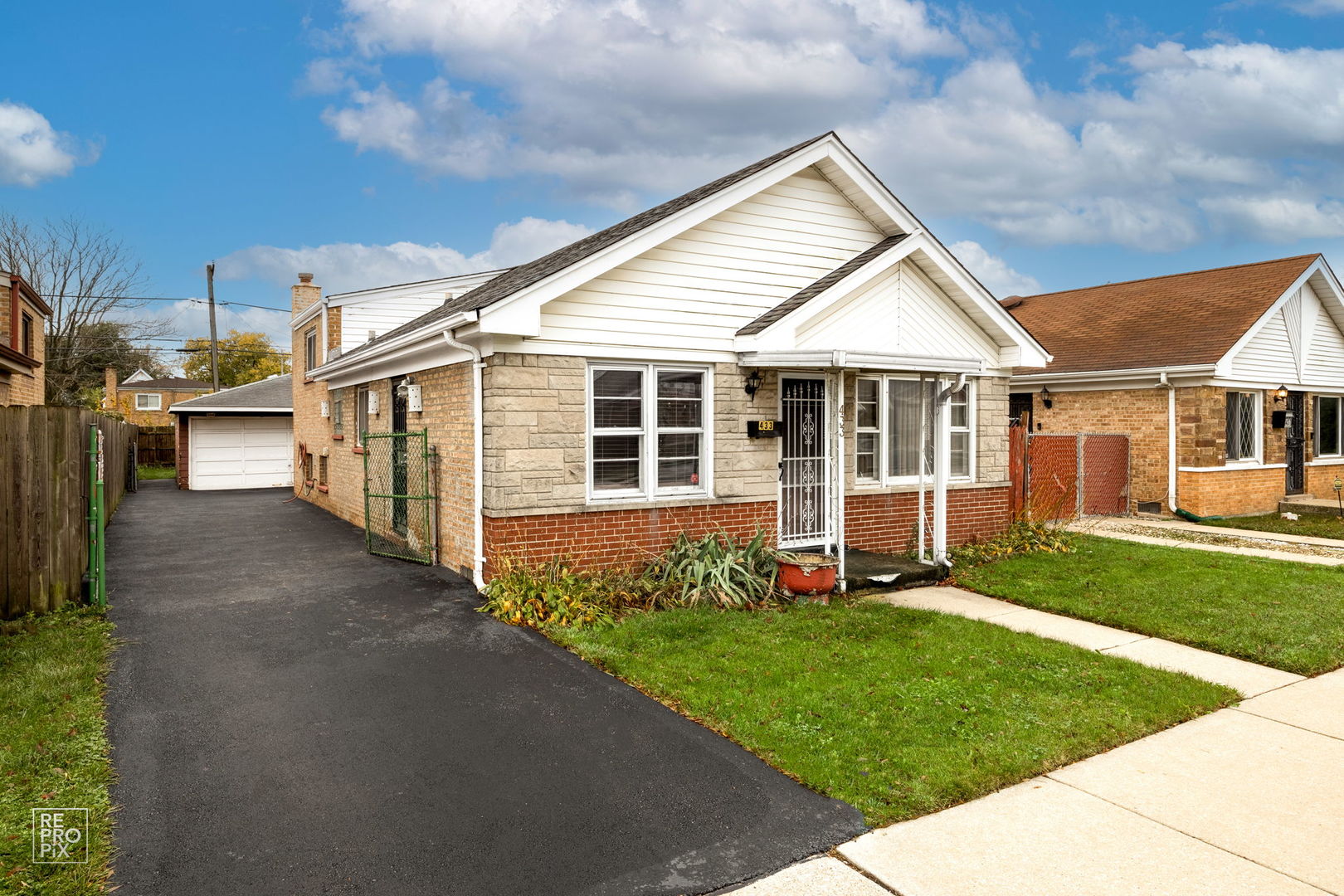 a view of a house with a yard and sitting area