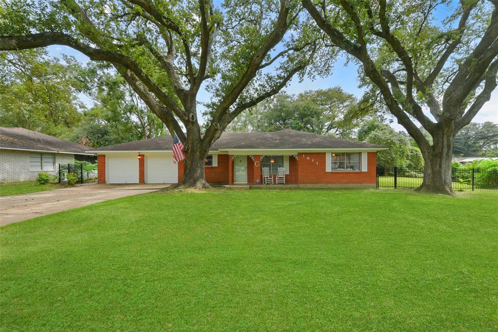 Welcome to 1611 Austin Street in The Highlands enclave in La Marque! This charming single-story brick home with a 2-car attached garage is situated on a little over a third of an acre park-like lot with a fenced backyard and sprawling shade trees.