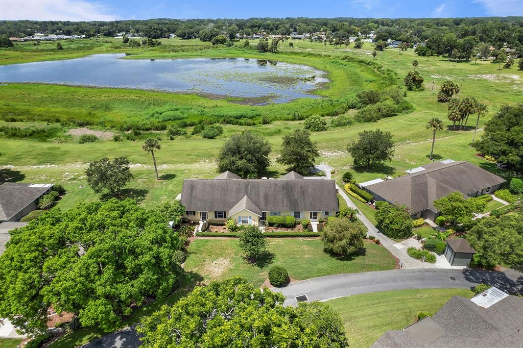 an aerial view of residential houses with outdoor space and street view