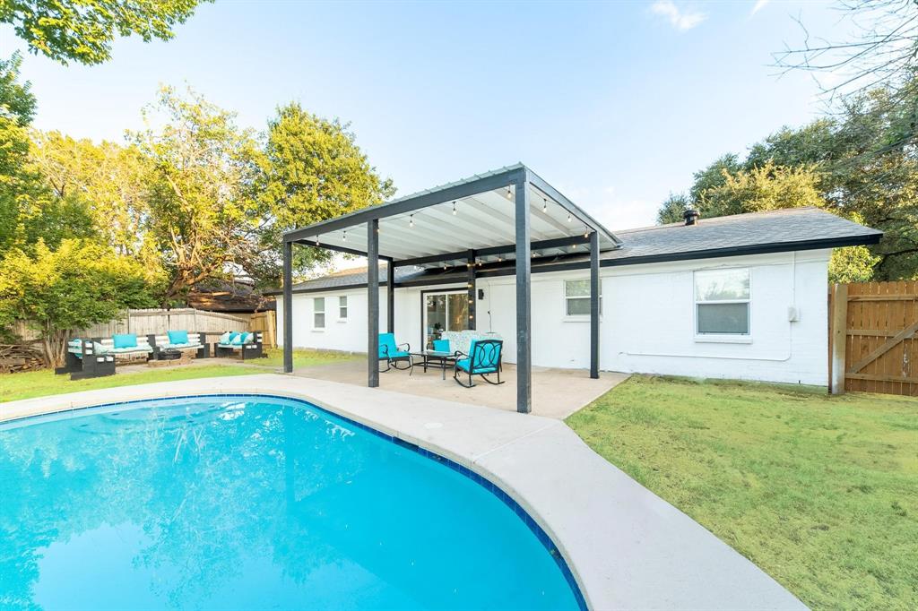 a view of a house with pool and chairs