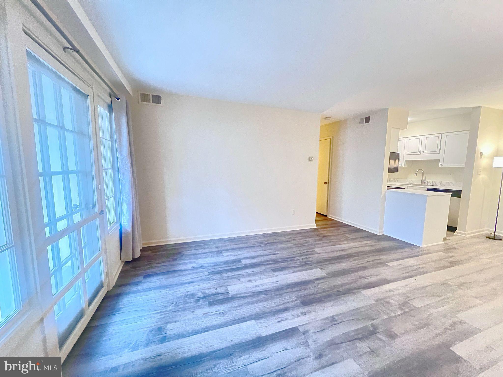 a view of a kitchen with wooden floor and a kitchen