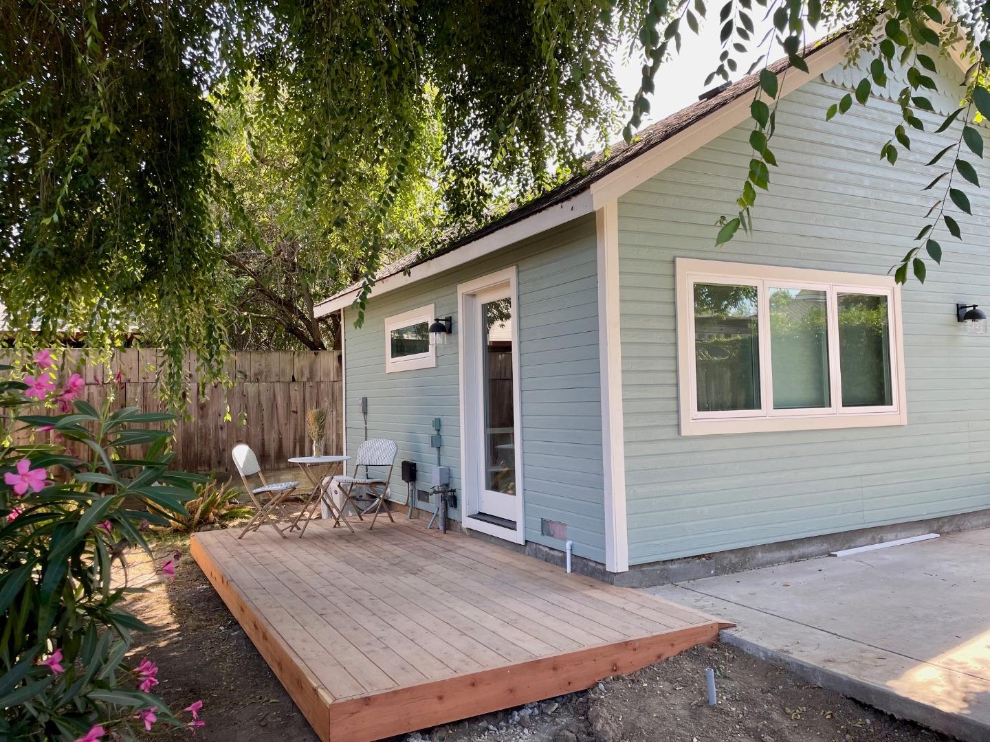 a wooden bench sitting in front of a house