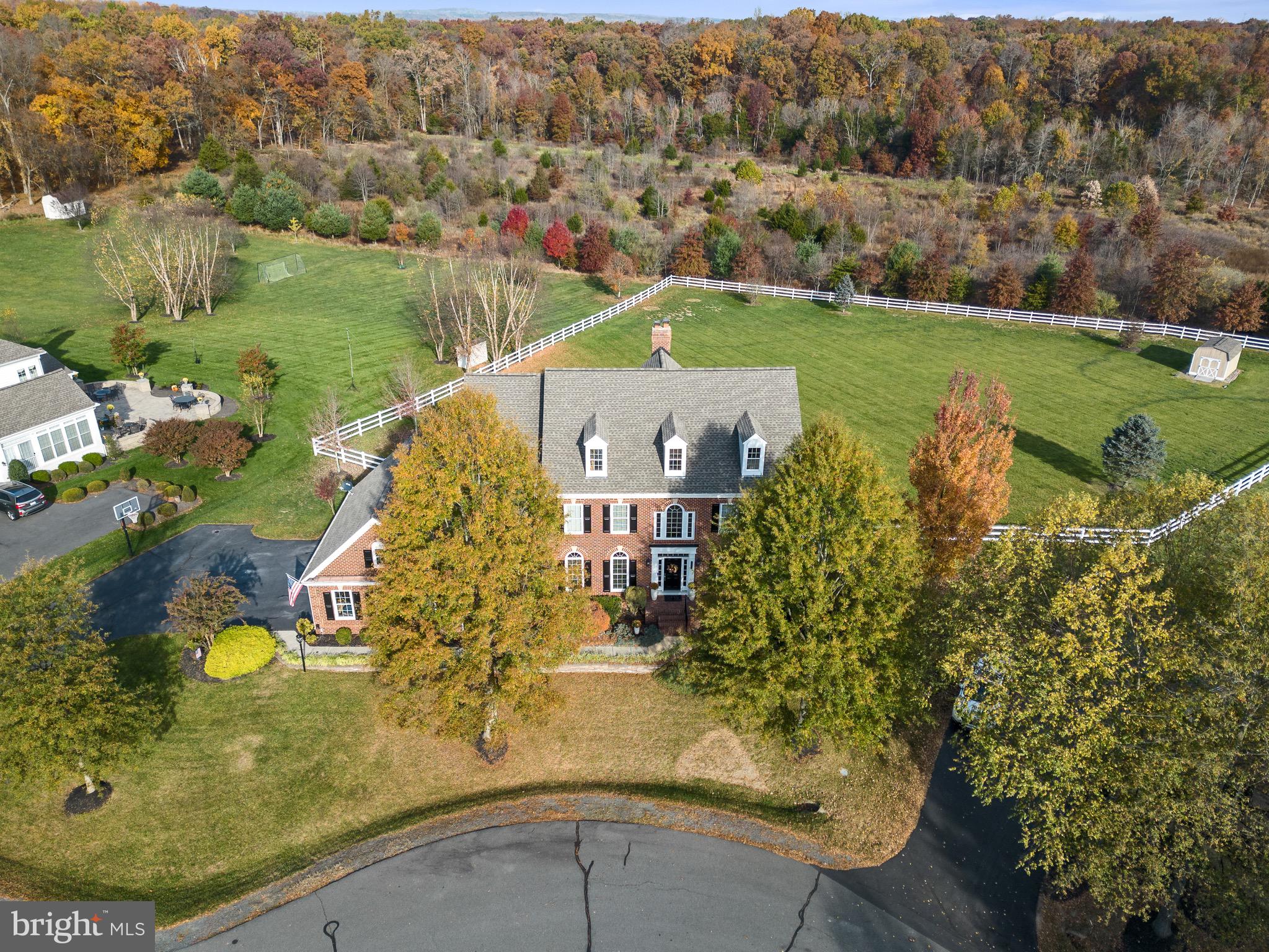 an aerial view of a house with yard swimming pool and mountains