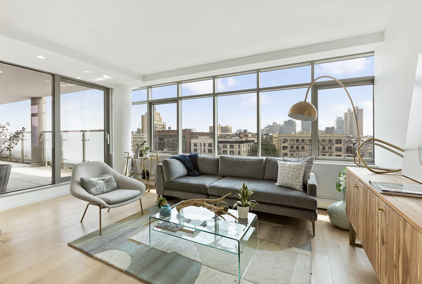 a living room with furniture and a floor to ceiling window