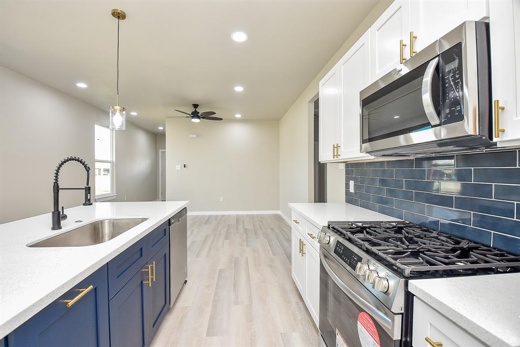 a kitchen with a sink and a stove top oven