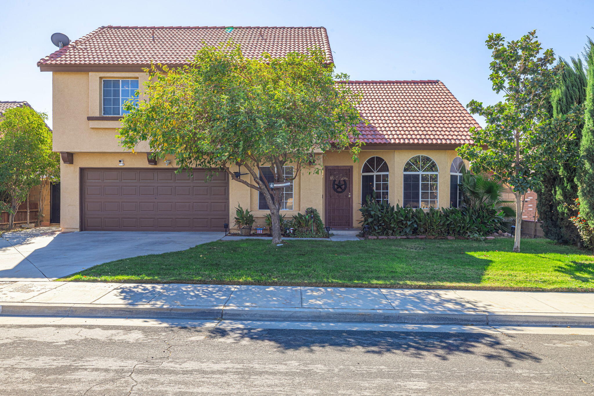 a front view of a house with a yard and garage