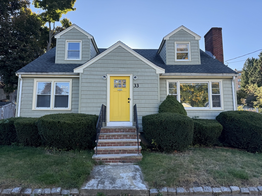 a front view of a house with a garden