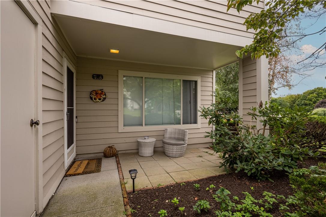 a front view of a house with chairs