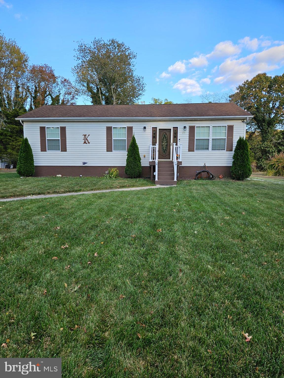 a front view of a house with a yard