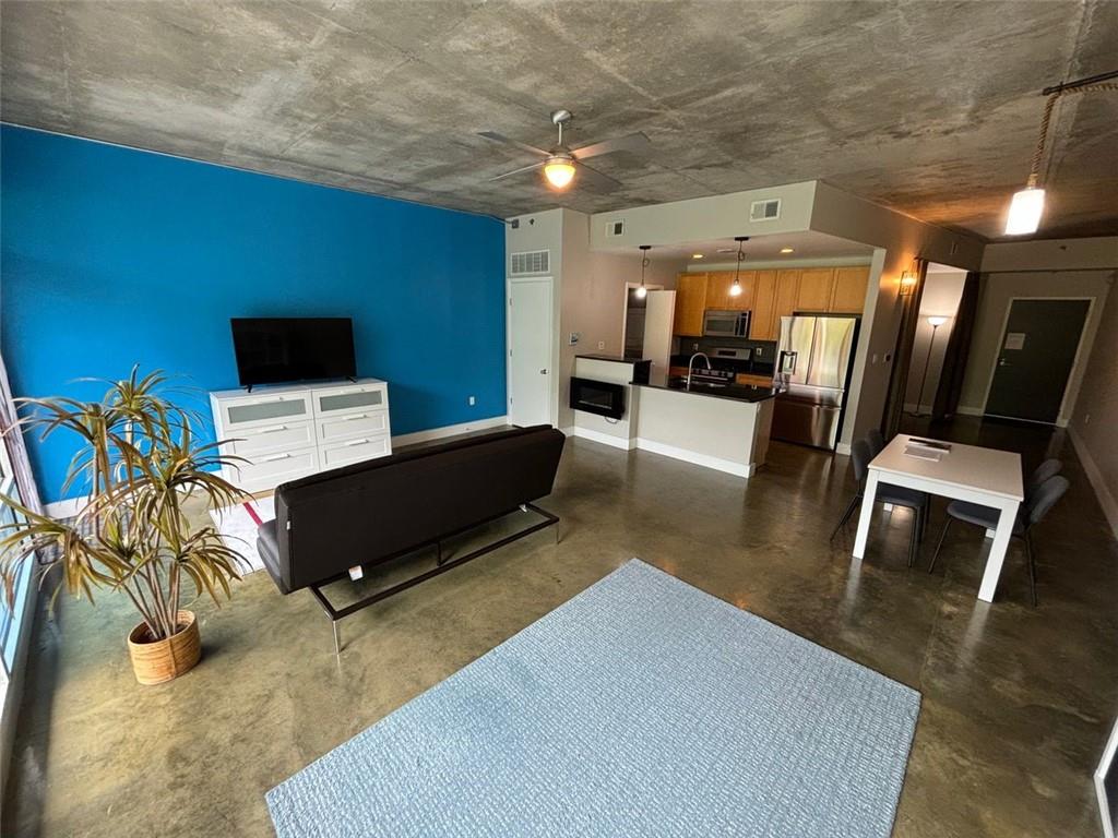 a living room with furniture and a flat screen tv