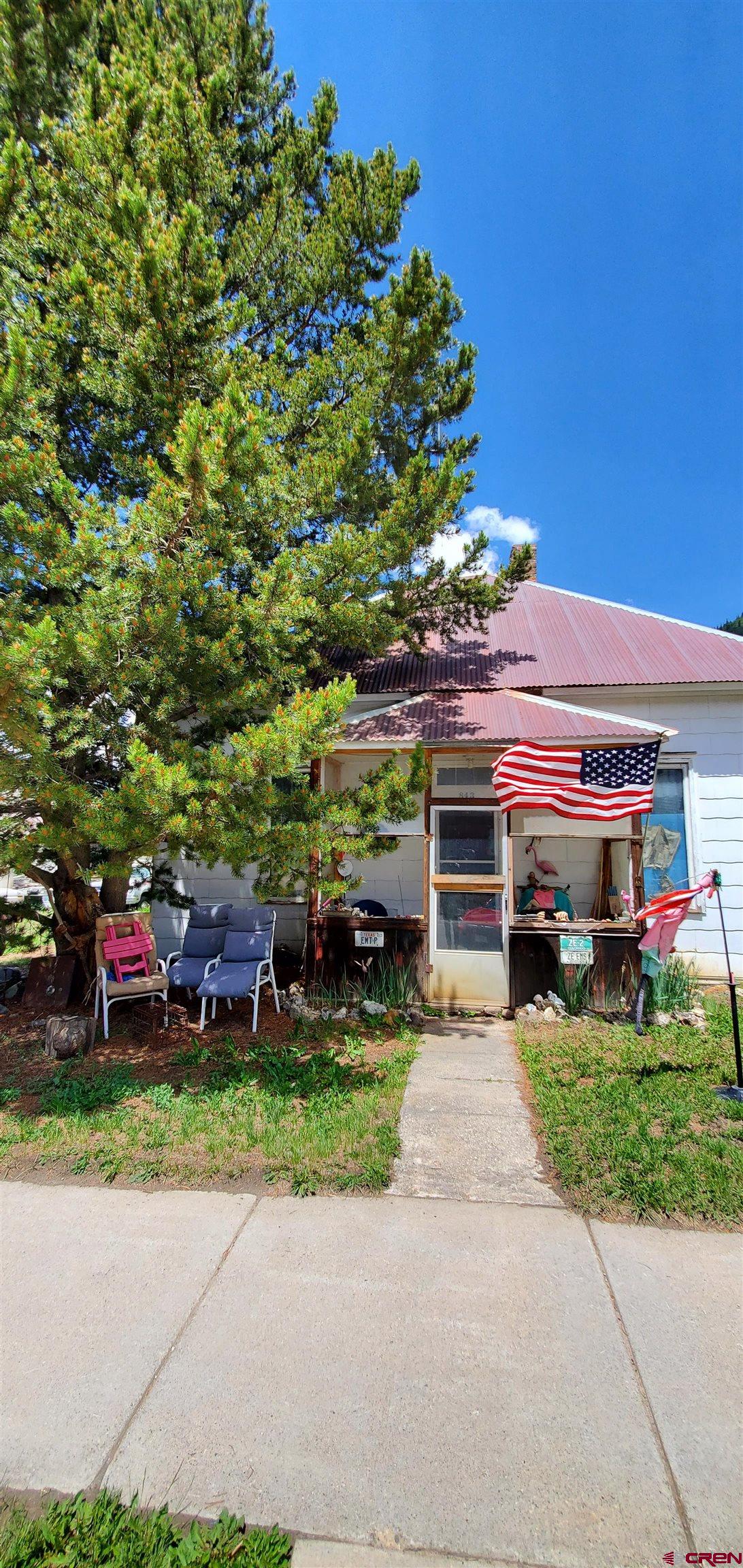 a view of a house with a yard and garage