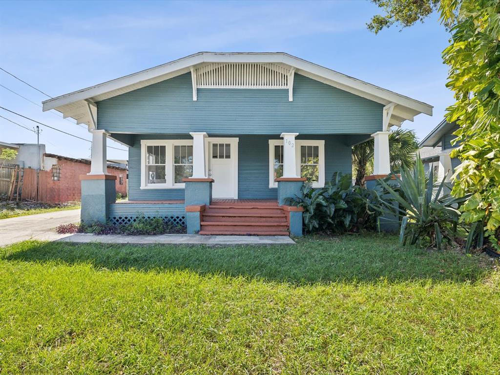 a front view of a house with a yard and porch