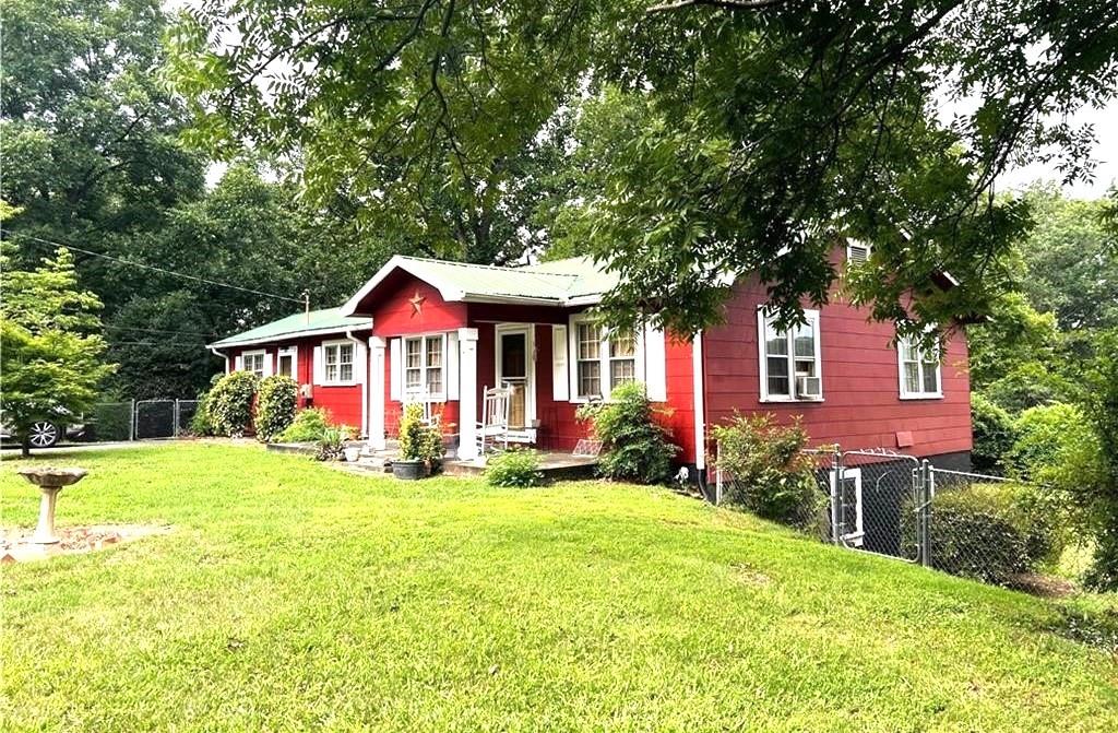 a view of a house with pool and yard