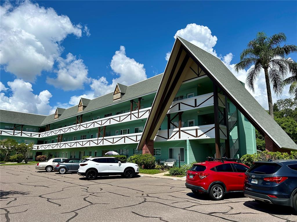 a view of a cars park in front of a building