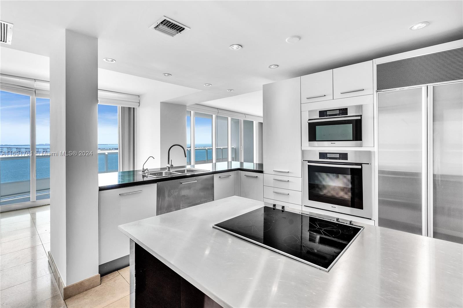 a kitchen with a sink a stove and refrigerator