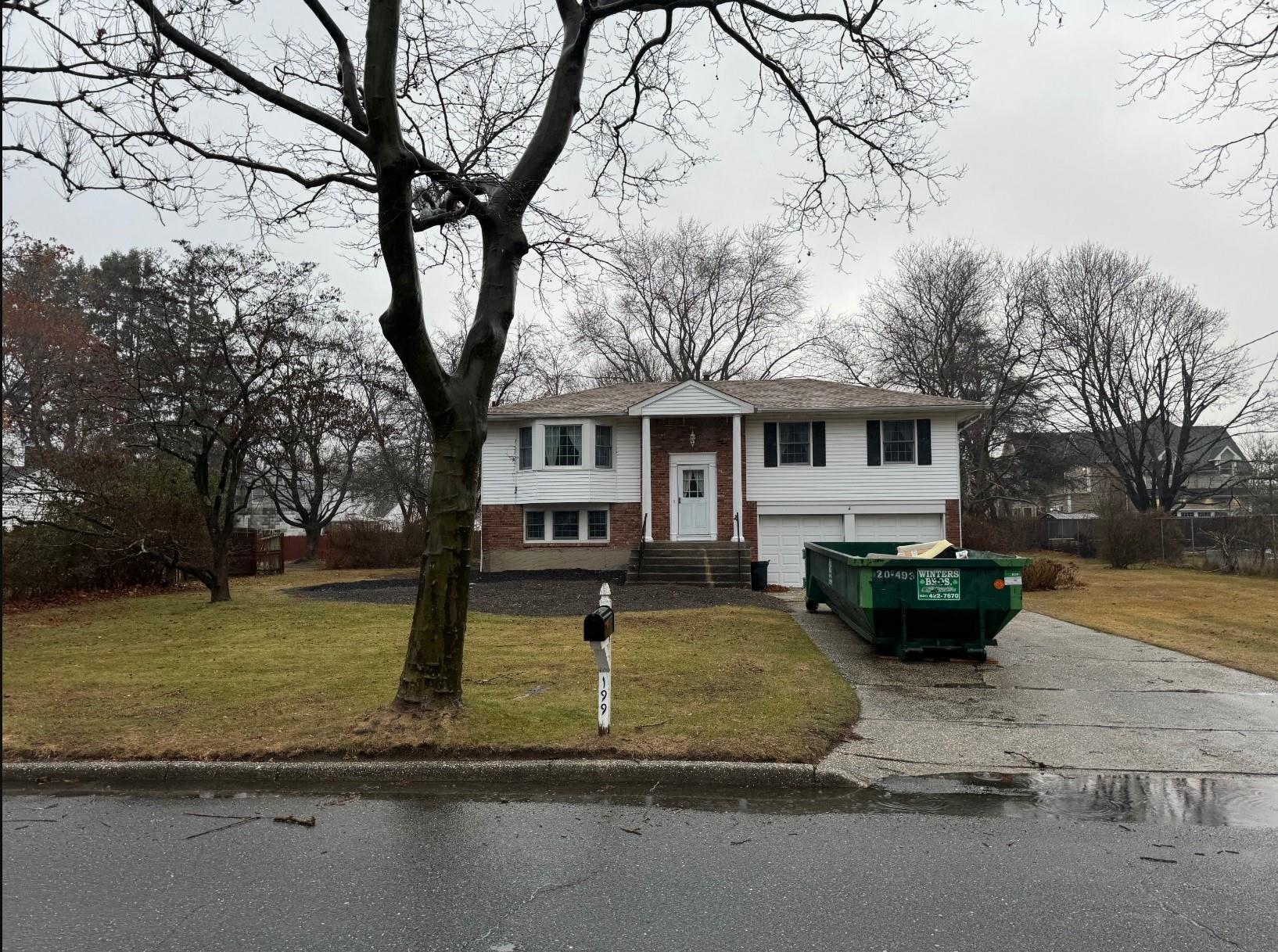 Bi-level home with a garage and a front lawn