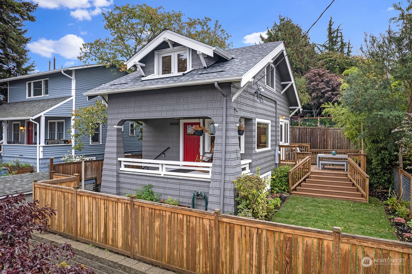 a view of a house with wooden fence