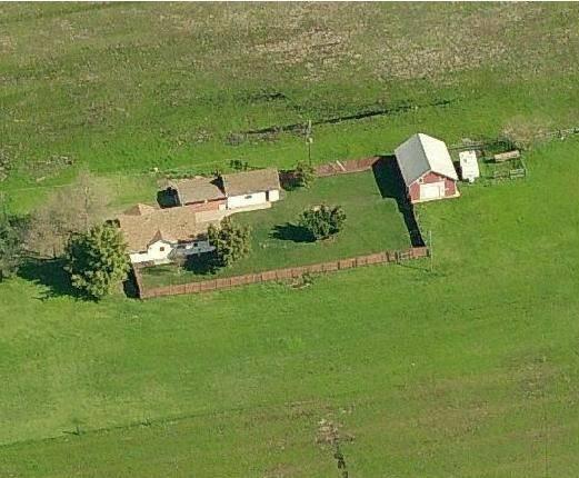 an aerial view of a house with a lake view