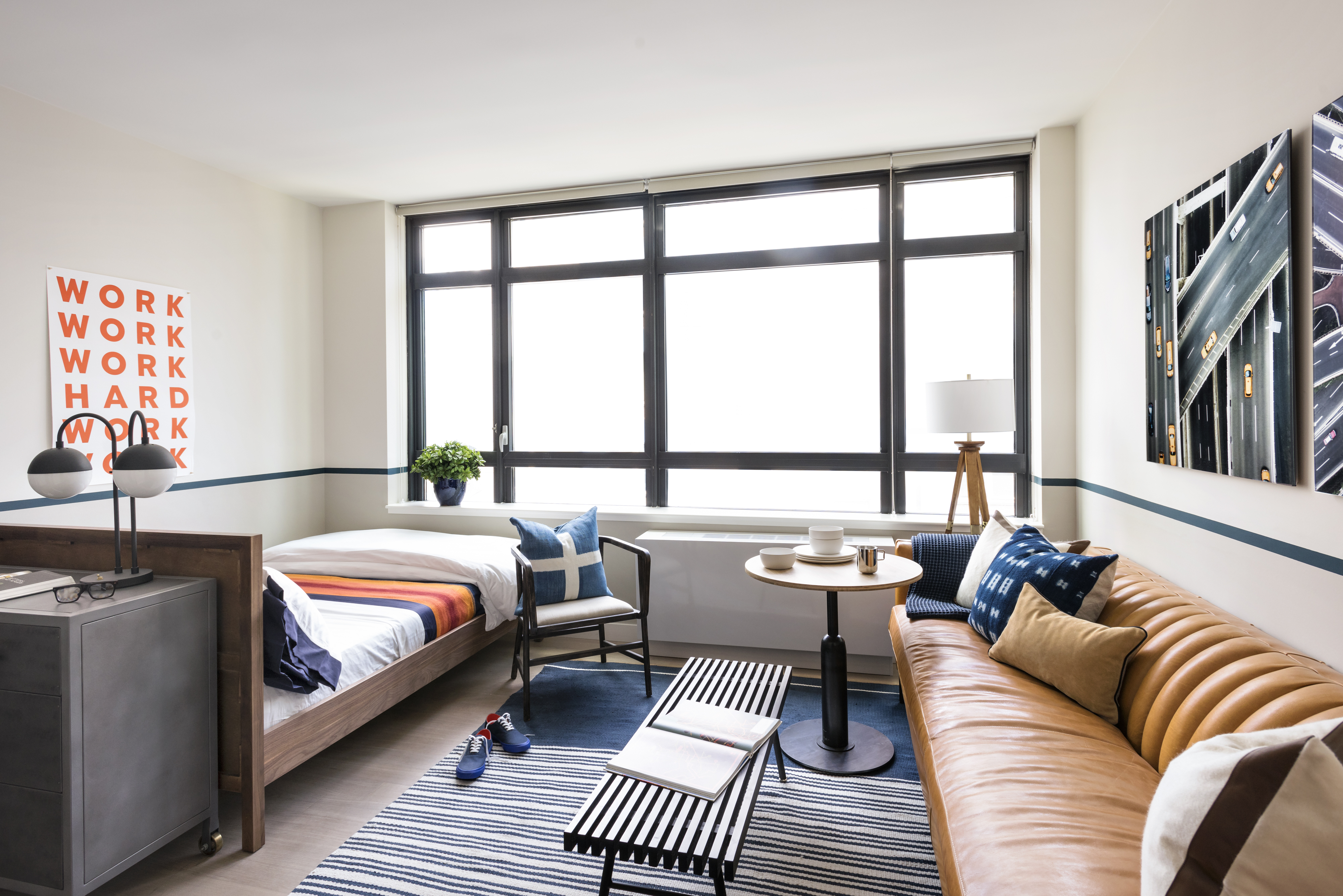 a bedroom with furniture and a large window