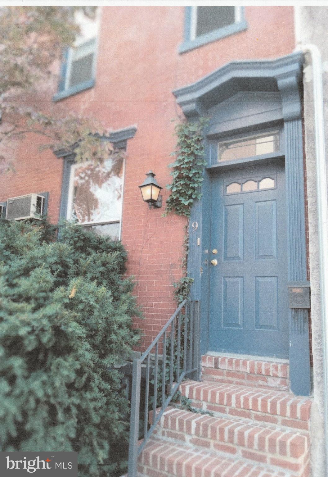 front view of a house with a bench