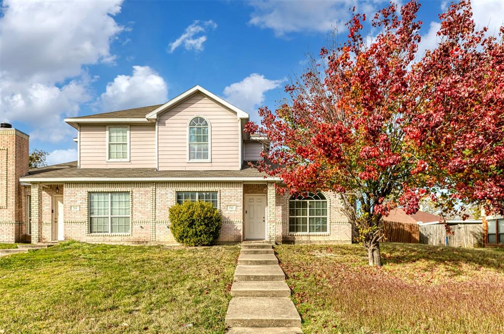 front view of a house with a yard