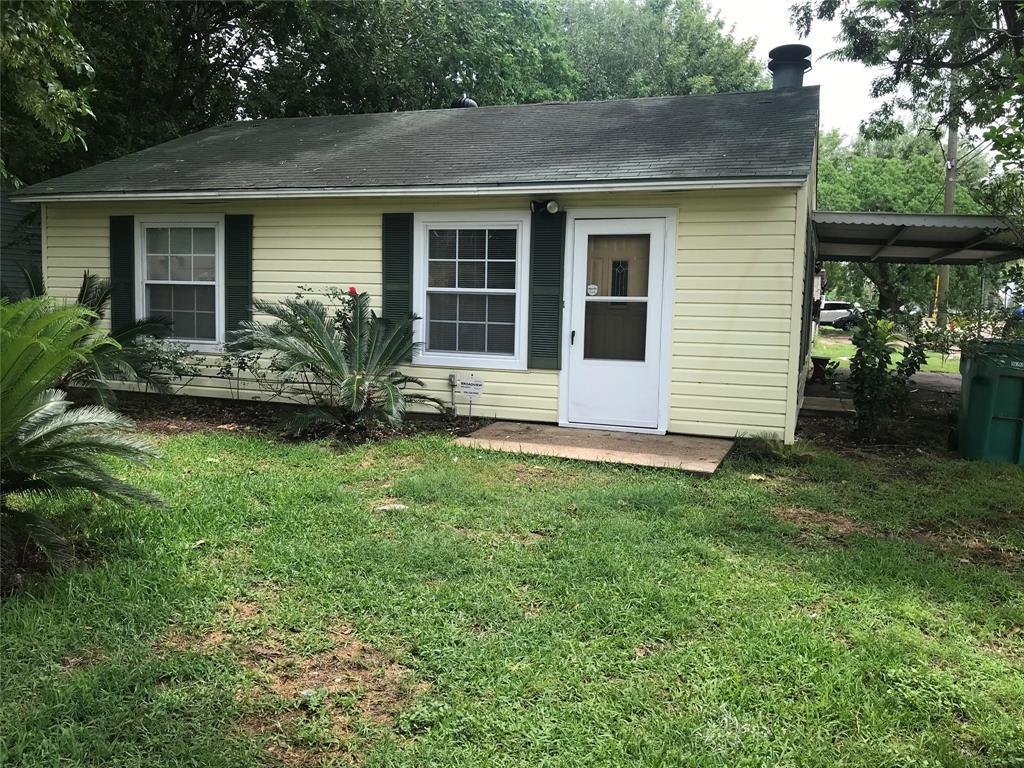 Front of home showing the carport on the side leading to the garage.