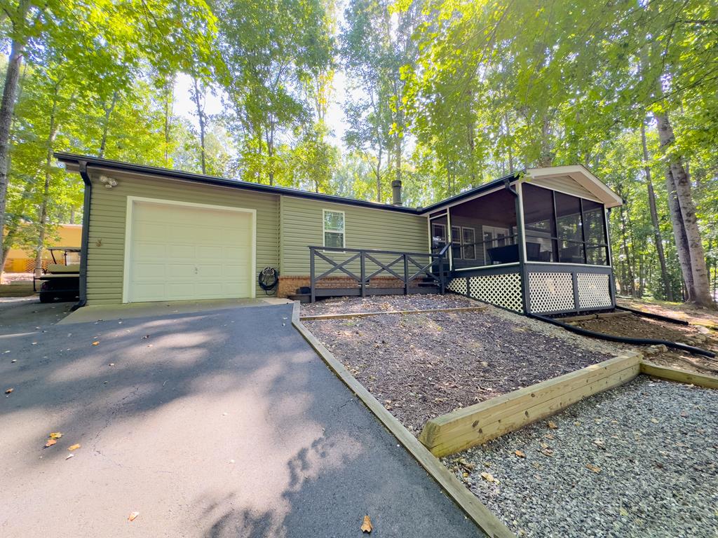 a view of a backyard with a barbeque area and wooden fence