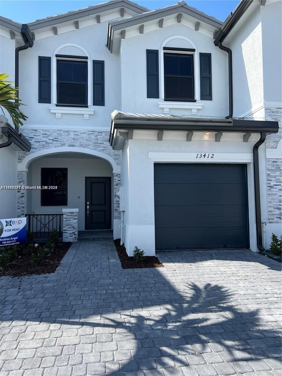 a front view of a house with a garage