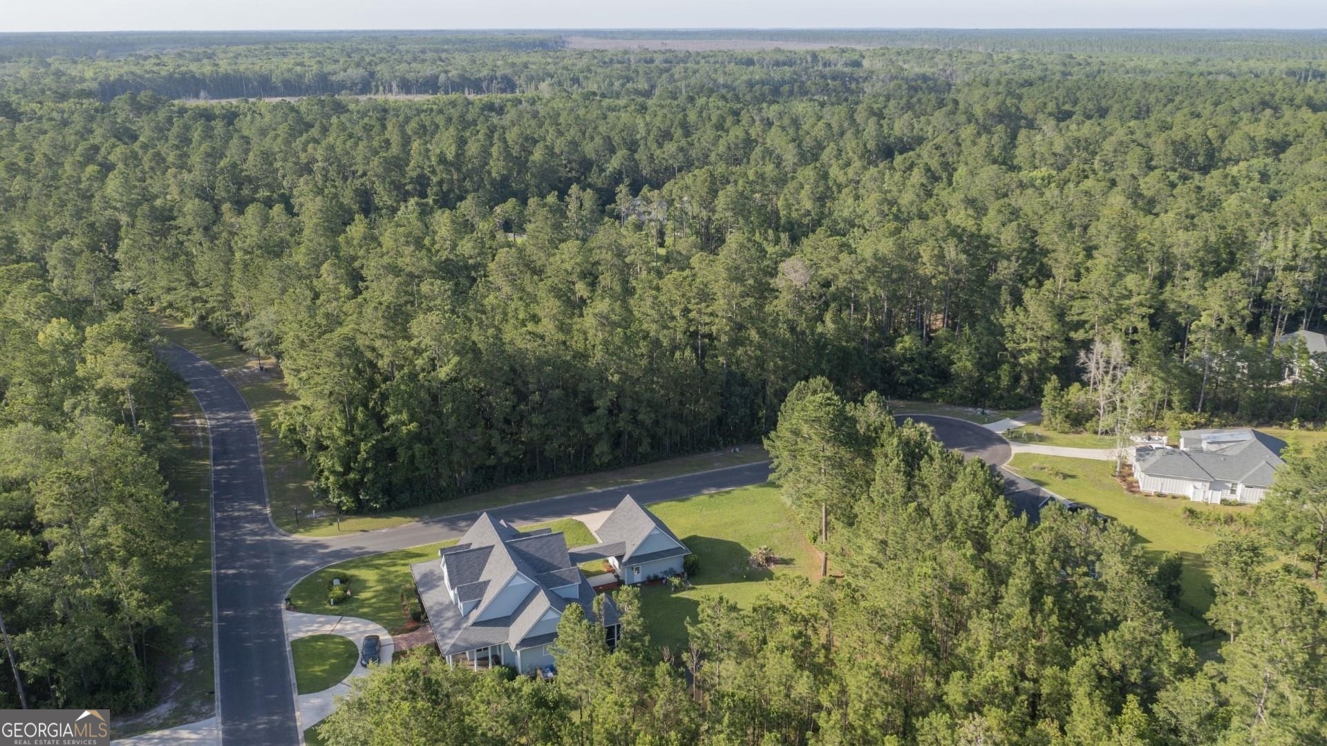 an aerial view of a house with pool garden