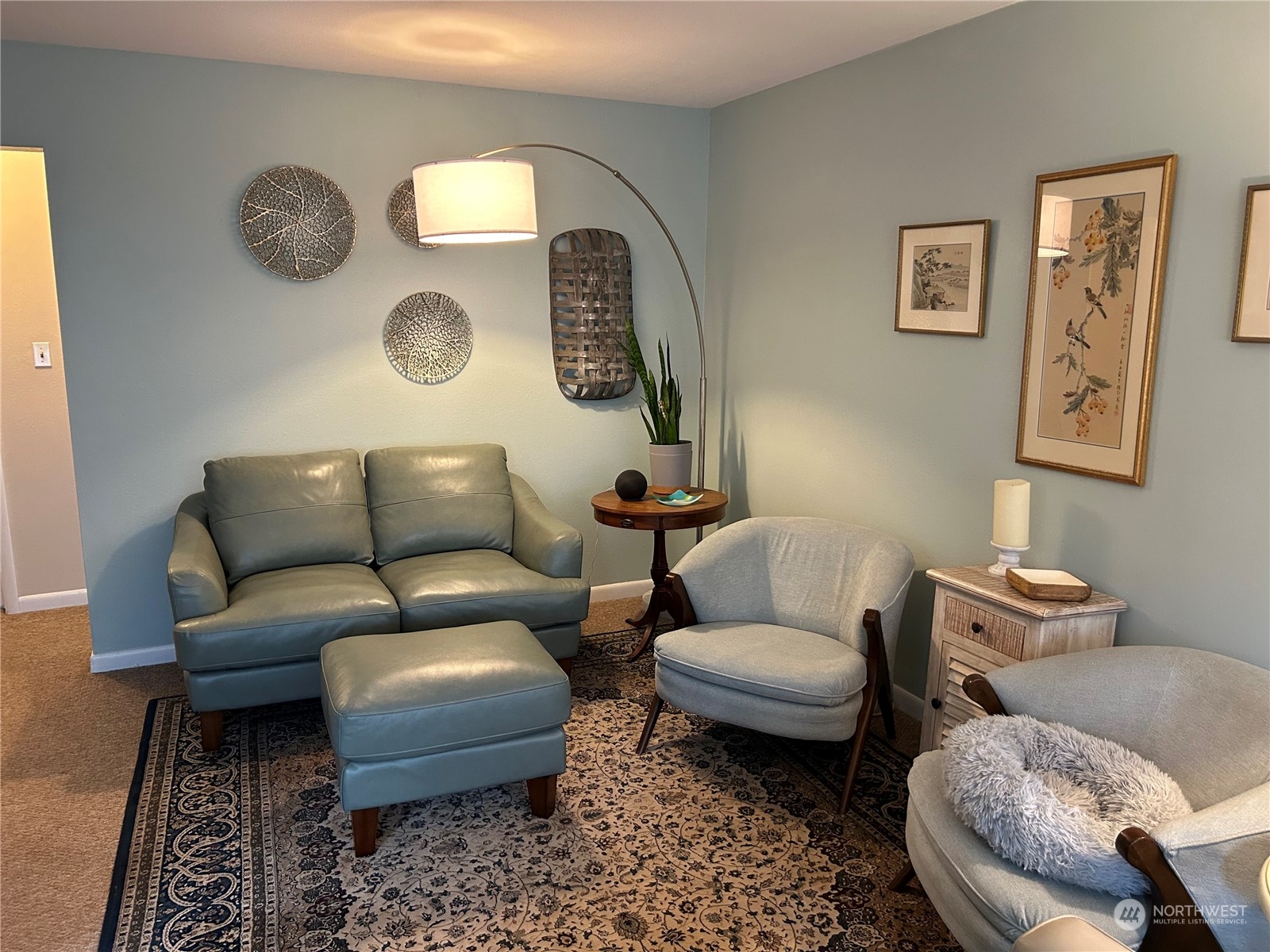 a living room with furniture and a mirror