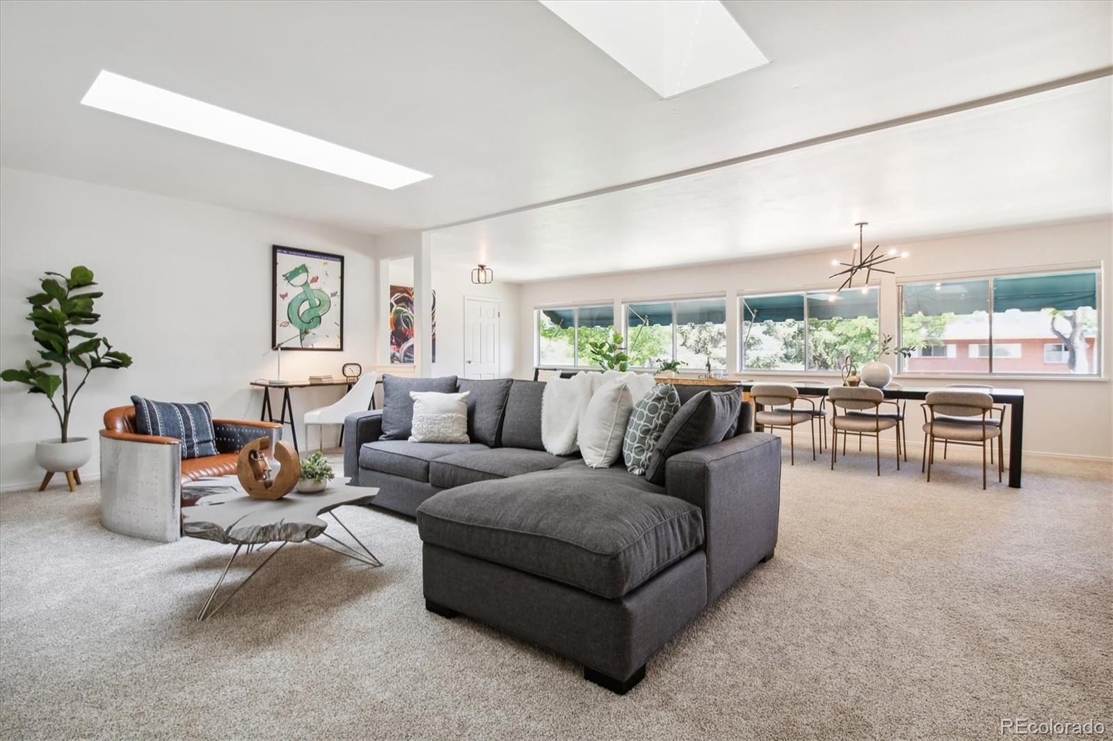 a living room with furniture and view of kitchen