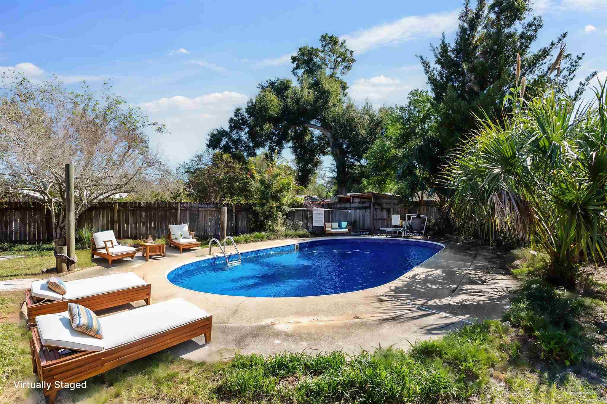 a swimming pool with outdoor seating and yard