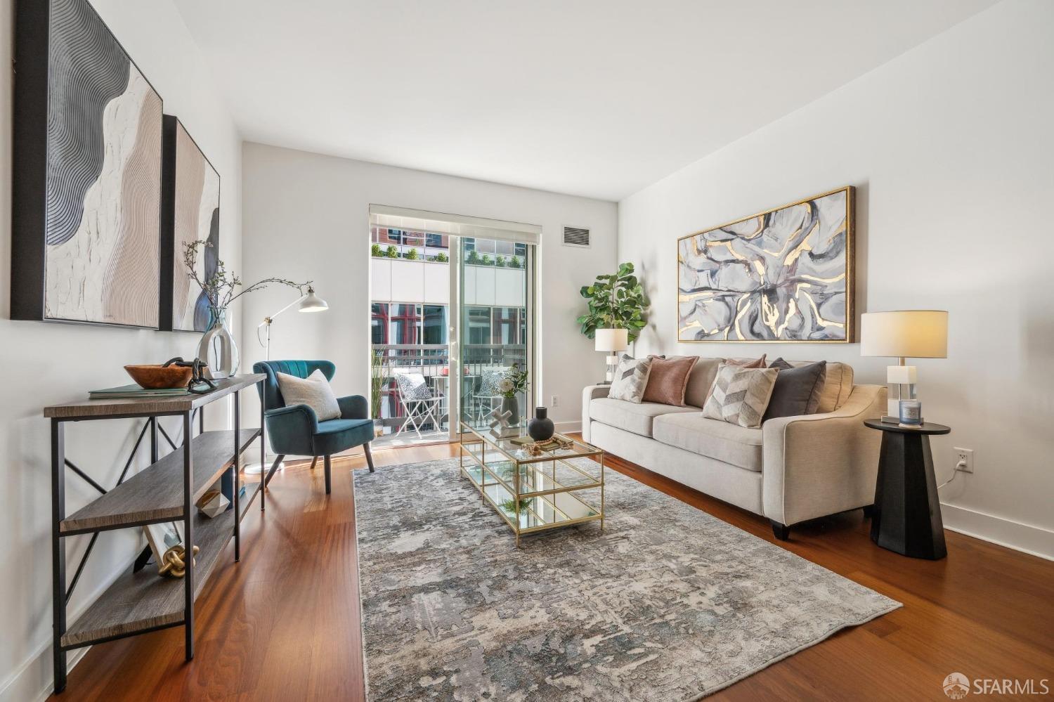 a living room with furniture and a wooden floor