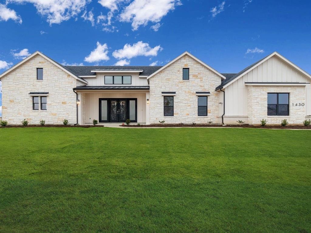 a front view of house with yard and green space