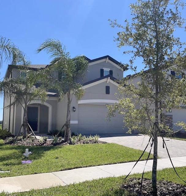 a front view of a house with a yard and garage