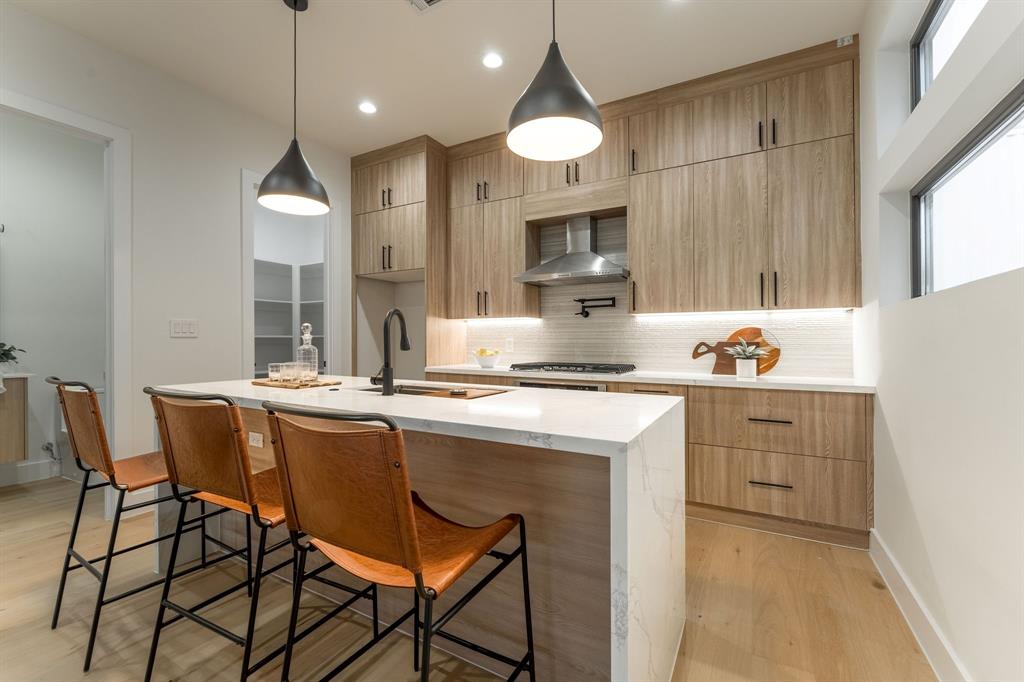 a kitchen with a sink cabinets and window