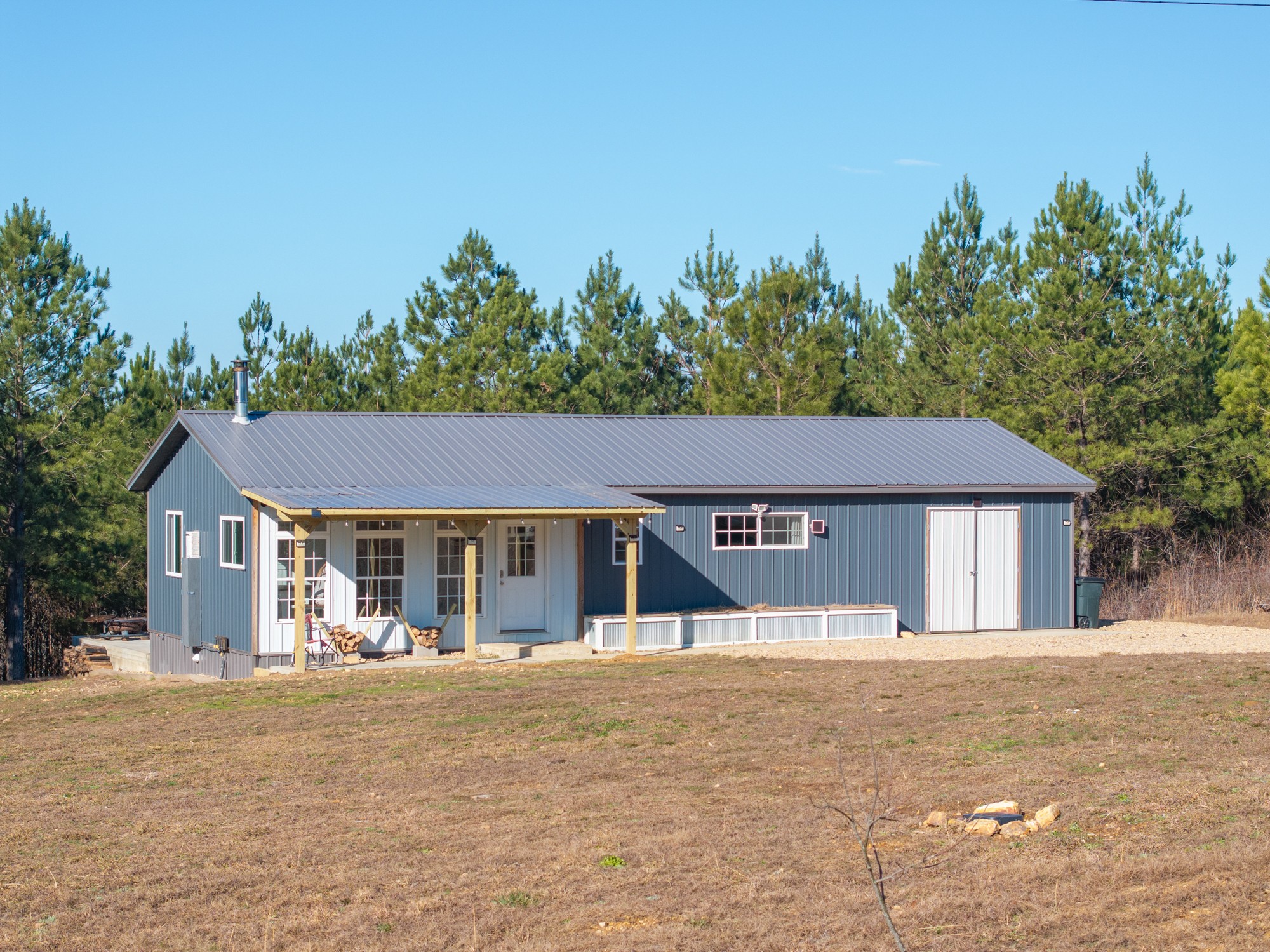 a front view of a house with a yard and trees