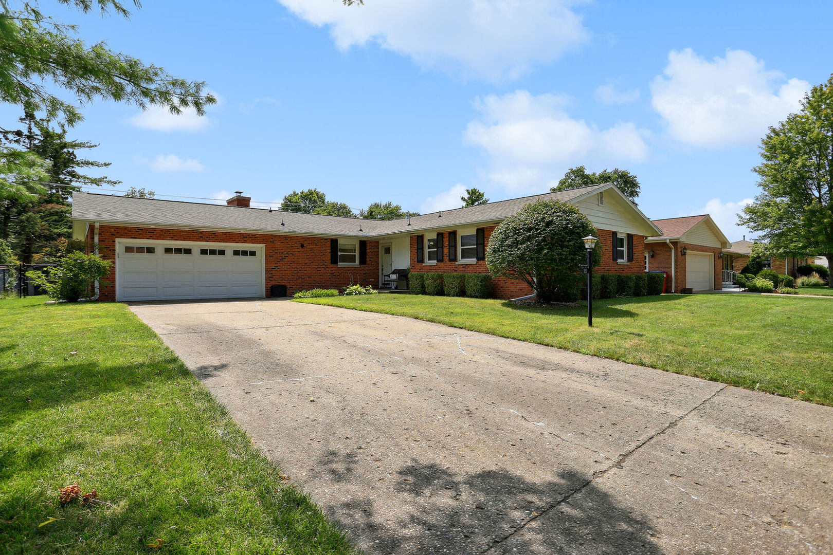 a view of house with yard and green space